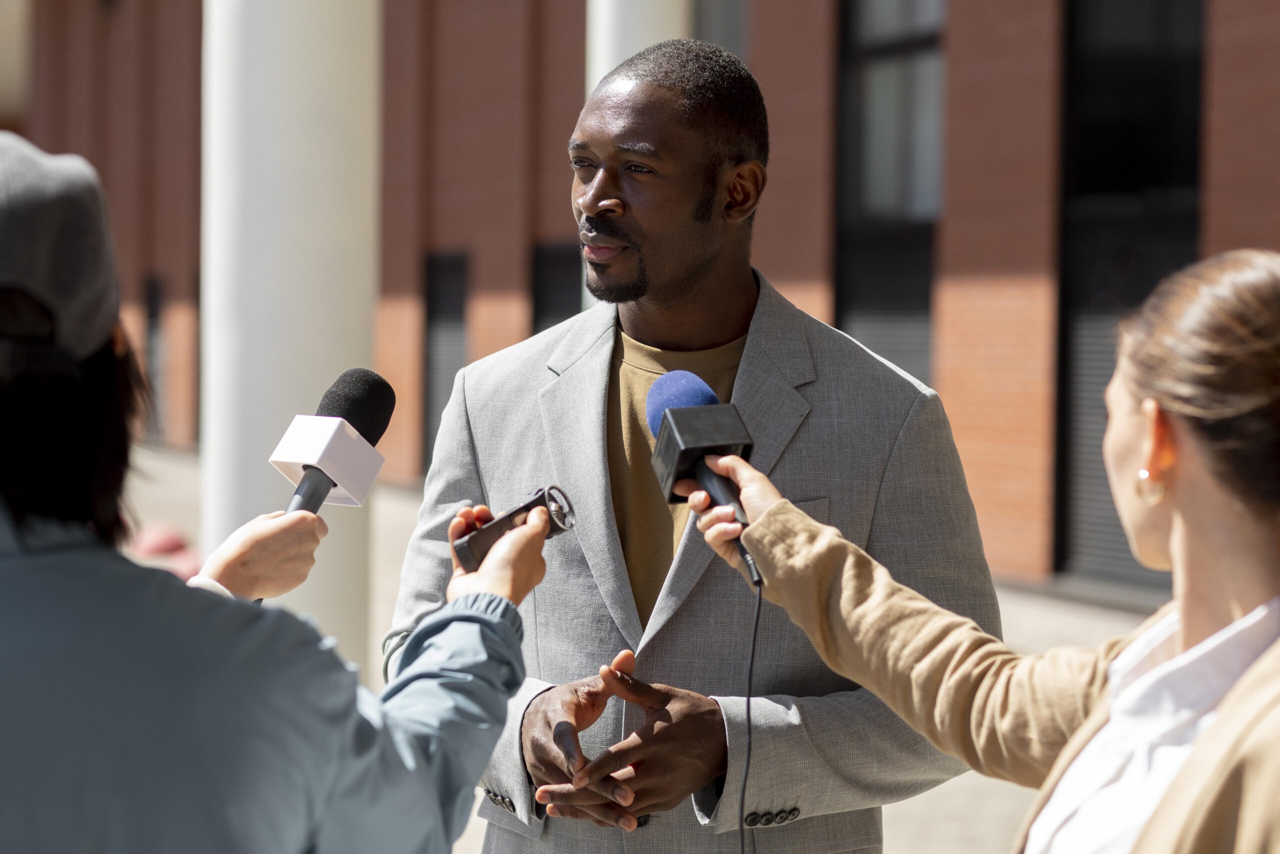 a man being interviewed by journalists
